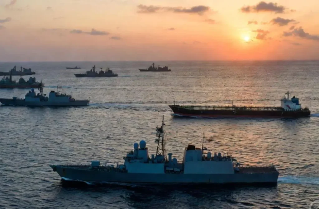 US-Iran Blockade and Ceasefire: Rethinking Power in Leadership 1 Naval warships and oil tanker in the Strait of Hormuz during the US-Iran blockade and ceasefire at sunset, highlighting the tension between military pressure and diplomatic efforts