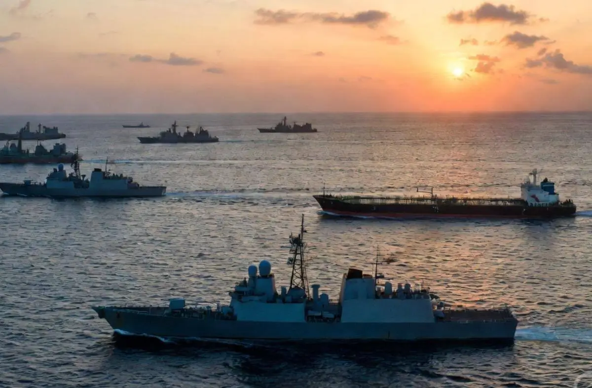 US-Iran blockade and ceasefire: Naval warships and oil tanker in the Strait of Hormuz at sunset, illustrating rethinking power in leadership